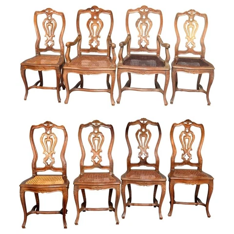 Eight Italian Renaissance Revival Carved Fruitwood and Caned Dining Chairs Cover