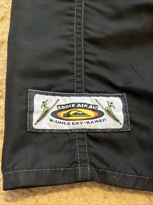 QUIKSILVER EDDIE AIKAU WOULD GO WAIMEA BAY HAWAII 1992 33” BLACK SURF SHORTS - Image 1 of 4