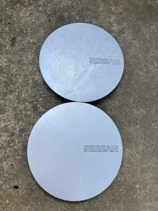 (2) Nissan 40315-40F00 silver wheel center caps for Maxima - Picture 1 of 3