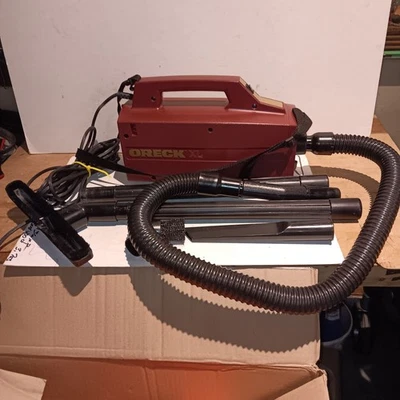 ORECK XL BB870-AQ Handheld  Vacuum w/strap, attachments, 3 new bags, Burgundy  - Image 1 of 3