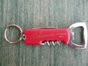 Porte-clé publicitaire SAUMUR ACKERMAN brut en forme de canif décapsuleur - Imagen 1 de 2