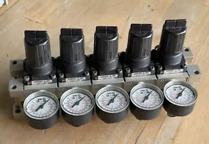 SMC NARM2500-B-N02 MANIFOLD OF 5 PNEUMATIC REGULATORS 0.05-0.85MPa 1/4" NPT - Picture 1 of 7