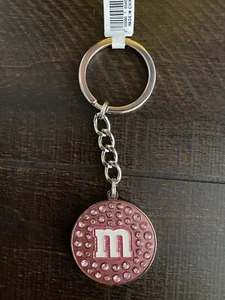 Schlüsselanhänger M&M's World rosa Linse mit Steinen Metall - Bild 1 von 2