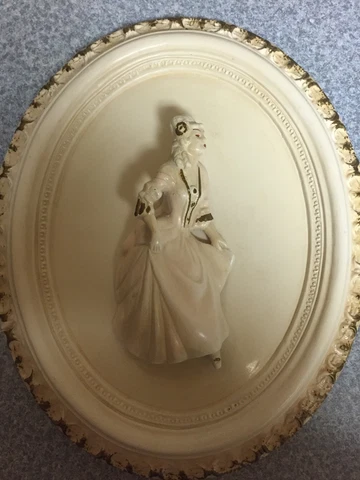 Oval hard plaster wall plaque with raised Edwardian lady. Decorative edging Cover