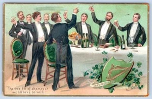 1909 CHAMPAGNE BOTTLES TOASTING TO SHAMROCK TUCK'S EMERALD ISLE POSTCARD - Picture 1 of 2