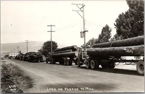Pacific Northwest Logging RPPC Postcard "LOGS ON PARADE TO MILL" Laws Photo 1919 - Picture 1 of 2