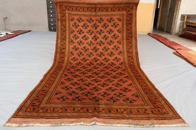 Alfombra afgana Taimani rústica 4x7 - Motivos de estrellas tribales repetitivos en alfombra de terracota. Foto 1 de 4