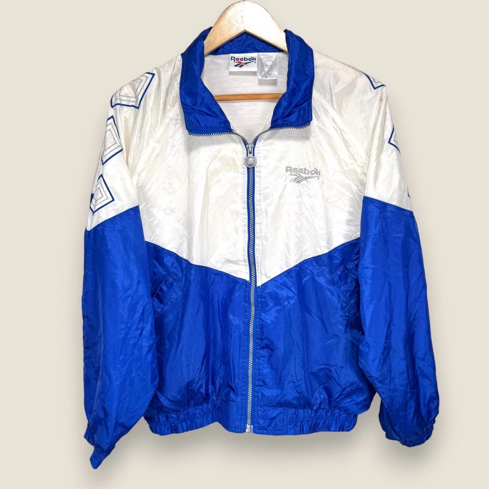 Chaqueta cortavientos Reebok vintage para mujer mediana blanca azul plateada años 90 cremallera completa Foto 1 de 4