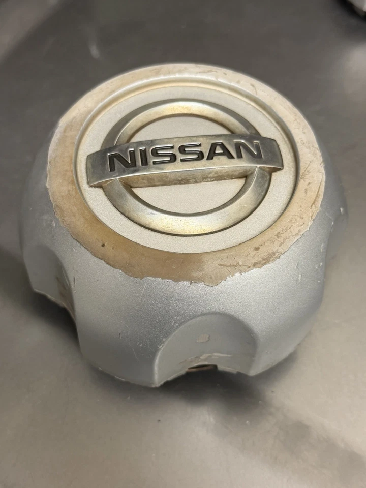 Tapa central rueda Nissan Frontier/Xterra 40315-1Z800 emblema cromado 1998-2004 Foto 1 de 4