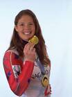 Picabo Street USA takes a bite of a chocolate gold medal as she we- Old Photo
