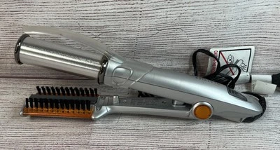 Plancha caliente giratoria Instyler IS1001 plateada y naranja con protector térmico Foto 1 de 4