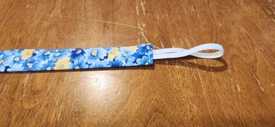 Pacifier Clip In A Blue And Yellow Floral Pattern - Image 1 of 3
