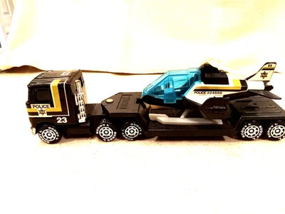 Camión/remolque de plataforma plana Police Mack 1985 "BUDDY L" de colección con helicóptero gira Foto 1 de 4