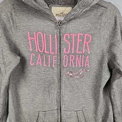 Hollister Sudadera con Capucha Mujer Gris Medio Rosa Bordado California Lentejuelas Logo Cremallera Foto 1 de 4