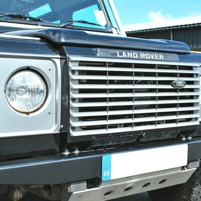 LAND ROVER DEFENDER FRONT GRILLE & HEADLIGHT SURROUND IN INDUS SILVER DA1257 - Image 1 of 2