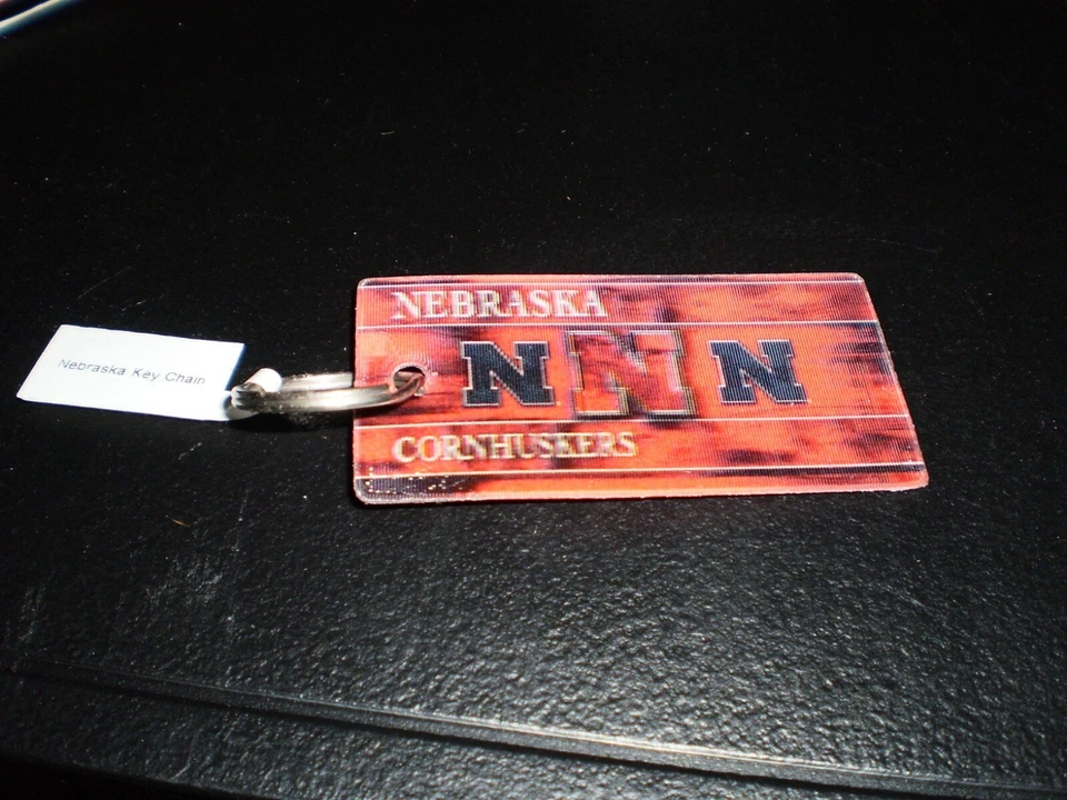  Lot Of 4   Nebraska Cornhuskers Keychain NCAA Team Logo  Printed Key Ring - Image 1 of 1