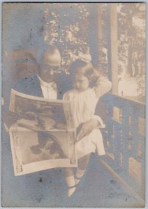 Periódico de lectura de hombre con escena de porche de niña, foto sepia de los años 1900-20 - Imagen 1 de 2