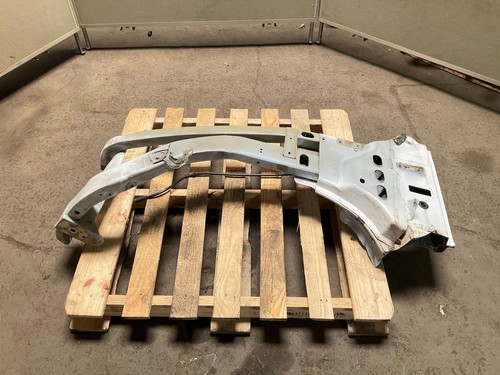 Silver 13-18 RAM 1500 front left driver frame apron radiator support on worn concrete, resting on a wooden pallet.