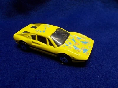 Matchbox Ferrari 308GTB #70 Yellow w/ Orange & Blue print on top of car - Image 1 of 3