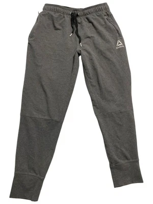Pantalones deportivos Reebok grises para hombre con cordón y bolsillos con cremallera logotipo talla M Foto 1 de 4