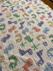 MUSLIN BLANKET WITH PASTEL DINOSAURS AND QUILTED BACK - Picture 1 of 8