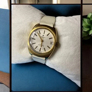 Vintage 1960s Stellaris 17J Swiss Auto Watch Gold Tone Date 7" White Strap WORKI - Picture 1 of 7