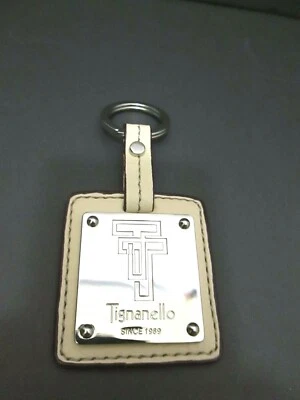 Llavero Tignanello FOB TT desde 1989 cuero metal usado en excelente estado anillo beige tostado de 2" x 4" Foto 1 de 3