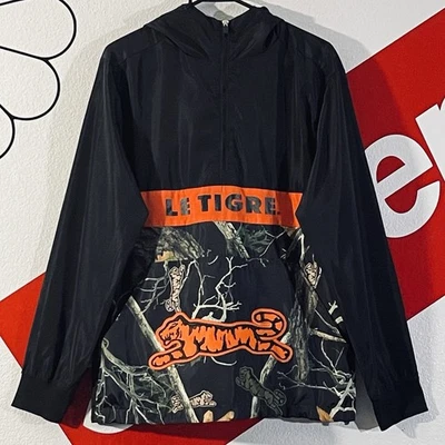 Chaqueta Le Tigre Para Hombre Pequeña Negra Camuflada Naranja Pullover con Capucha Rompevientos Tigre Foto 1 de 4