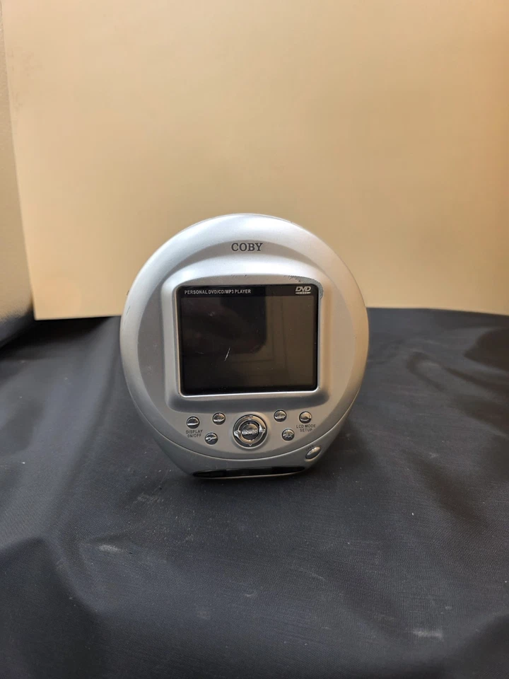 Reproductor de DVD ultra portátil Coby TF-DVD500/SIN cargador - PROBADO arañazos menores  Foto 1 de 4