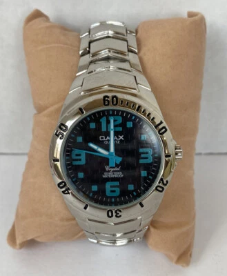Reloj Omax Cuarzo Cristal 50 Metros Impermeable Color Plata - Necesita Batería Foto 1 de 4