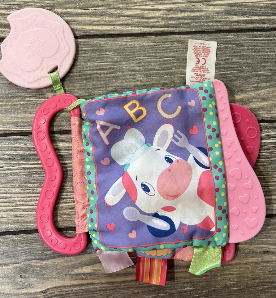 Libro de tela de tela arrugada rosa Bright Starts de 7” para bebé con dientes juguete para niños pequeños Foto 1 de 3