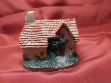 Resin English House With Brown Roof And Green Bushes Around The House