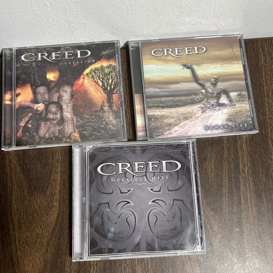 Lot of 3 CDs from Creed Human Clay, Greatest Hits, and Weathered - Image 1 of 3