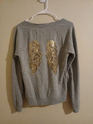Sudadera Victoria's Secret Oro Lentejuelas Alas de Ángel Gris Jaspeado Talla Pequeña Foto 1 de 4