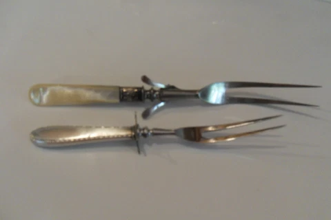 2 Vintage serving forks. 1 with Sterling silver handle 1 mother of pearl Cover