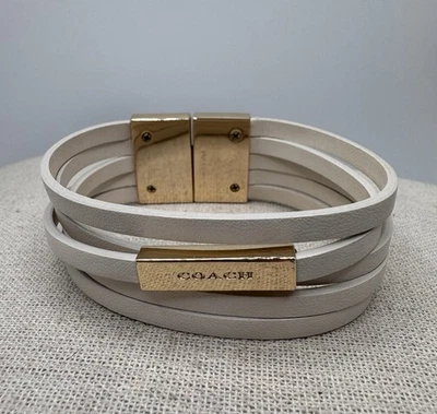 "Brazalete envolvente de cuero Coach tono dorado blanco roto 5 hilos 7,5""" Foto 1 de 4