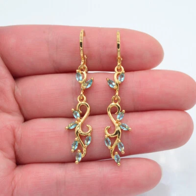 Pendientes estéticos artísticos de topacio místico azul lago rellenos de oro amarillo de 18 quilates para mujer Foto 1 de 3