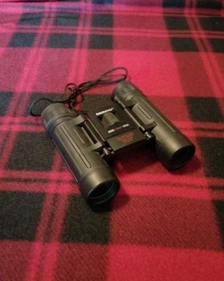 Tasco 10x25mm Binoculars Fully Coated Optics 288. Ft At 1000 Yards - Image 1 of 4