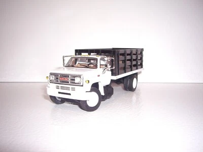 DCP FIRST GEAR 1/64 WHITE CAB BLACK STAKE SIDE GMC 6500 SINGLE AXLE STAKE TRUCK  - Image 1 of 4