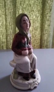 FLAMBRO Vintage Porcelain Older Woman Sitting On A Bench Holding Flowers Plants. - Bild 1 von 6