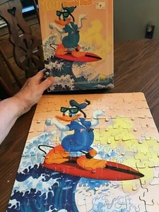 puzzle Paperino surf. 100 pezzi. Dorato. 11,5 x 15 pollici. Età 5+ Così - Foto 1 di 2