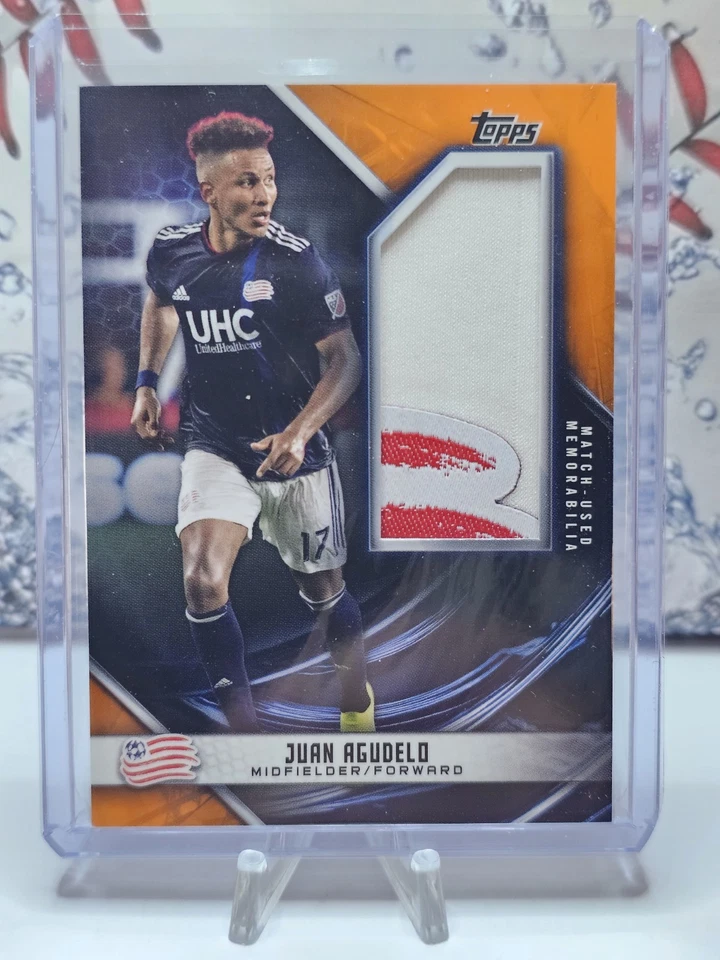 2019 Topps MLS /25 Orange Game Used Logo Patch Juan Agudelo New England!  B16 - Image 1 of 3