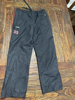 Pantalones de calentamiento de hockey Reebok Junior negros número 33 talla grande Foto 1 de 4