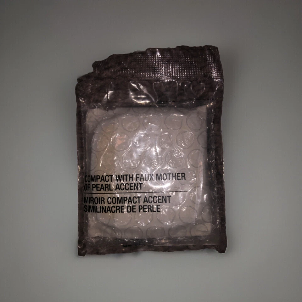 AVON COMPACT WITH FAUX MOTHER- OF- PEARL ACCENT MIRROR  - Image 1 of 1