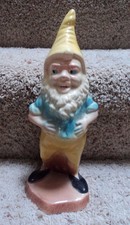 Vintage 10 1/2" tall Ceramic Gnome Standing next to tree stump